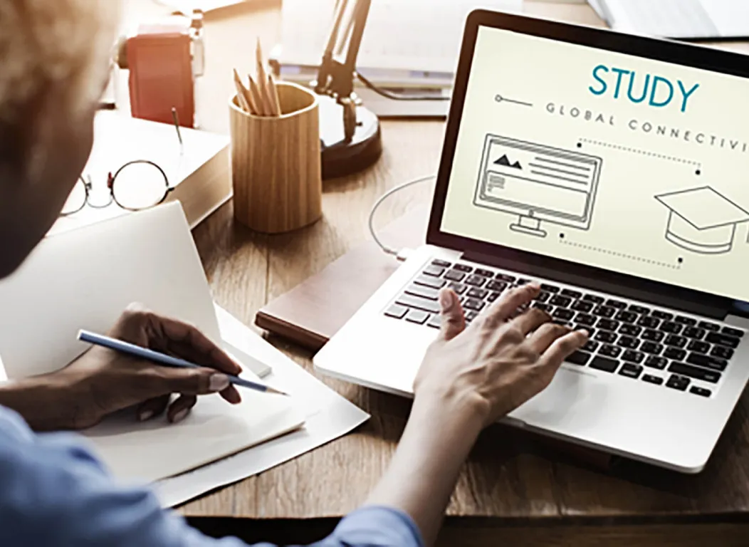 Continuing education student taking online classes on laptop.