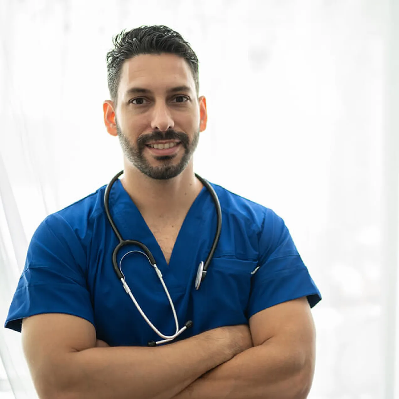 Male vocational nurse in blue scrubs wearing a stethoscope