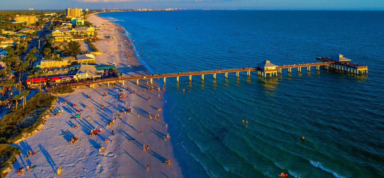 Aerial view of Fort Myers Beach and pier near Concorde Career College campus in Fort Myers, Florida at sunset.