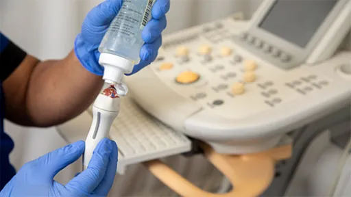 A cardiovascular sonographer readies a scanning tool.