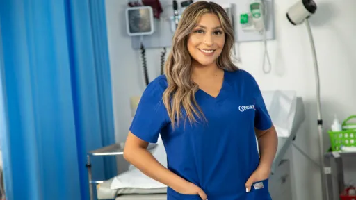 Concorde Medical Assistant graduate in blue scrubs.