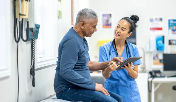 A nurse communicates with patient using a translation app.