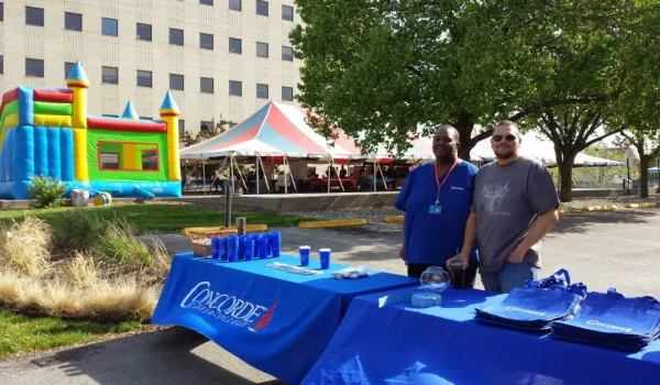 Concorde students in Kansas City greet visitors at a community health fair.