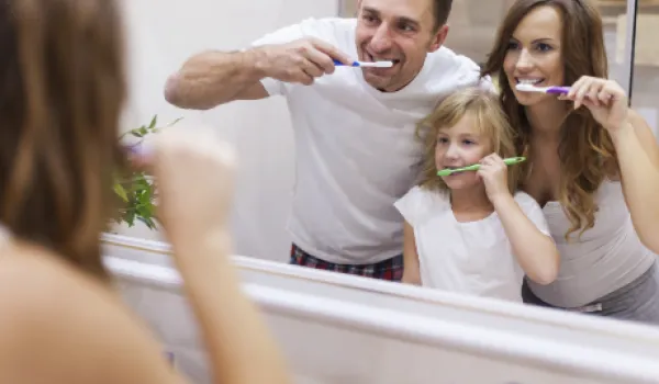 family brushing teeth