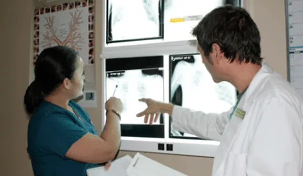 Student and Instructors looking at an x-ray.