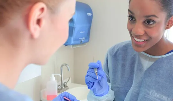 Dental hygienist with tool.