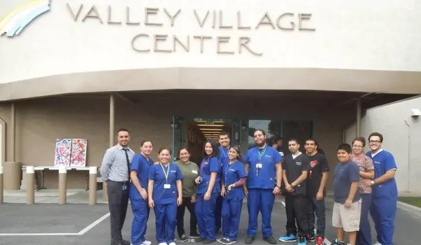 Concorde students standing outside Valley Village Center where they volunteer their time