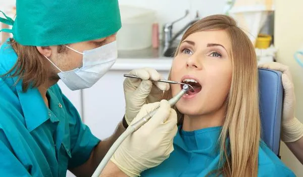 Patient gets teeth examined by hygienist.