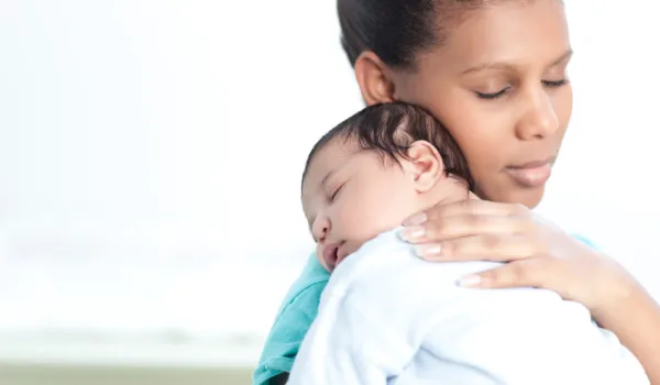 Mom relaxing newborn