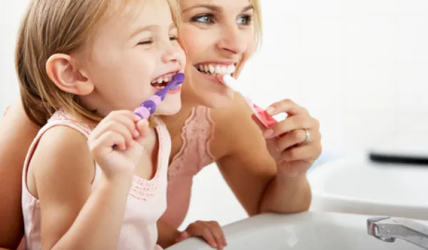 Mom and child brushing teeth