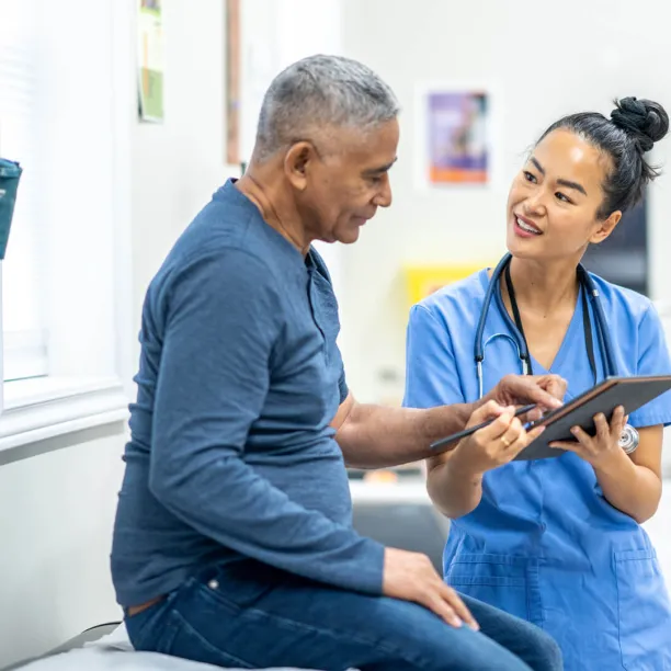 A nurse communicates with patient using a translation app.