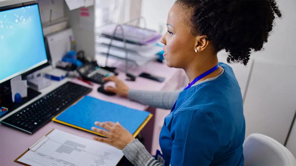 A medical assistant works to file medical records