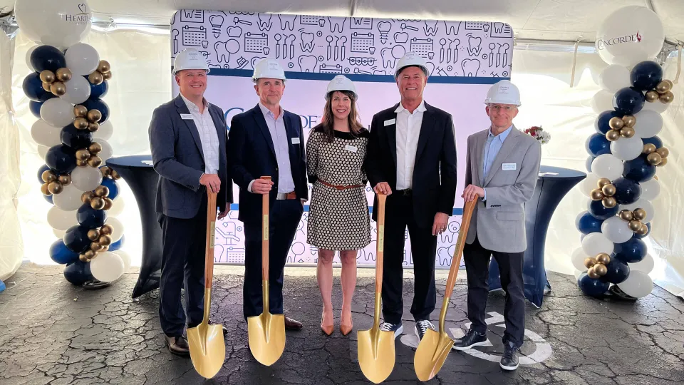 Concorde and Heartland Dental leaders at Fort Myers campus groundbreaking ceremony, holding gold shovels and wearing hard hats. Concorde and Heartland Dental leaders at Fort Myers campus groundbreaking ceremony, holding gold shovels and wearing hard hats.