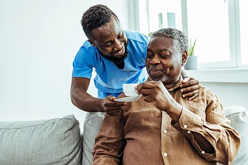 LVN offers a cup of espresso to his patient at their home.