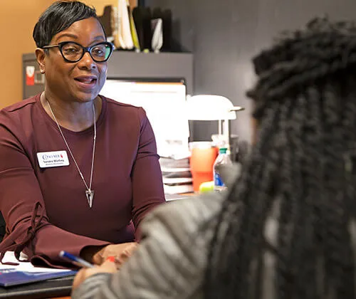 Concorde Admissions Rep talking with a woman in an office